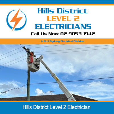Level 2 electrician on elevated platform performing overhead power line maintenance in Hills District